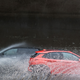 Two cars drive through puddles in New York City